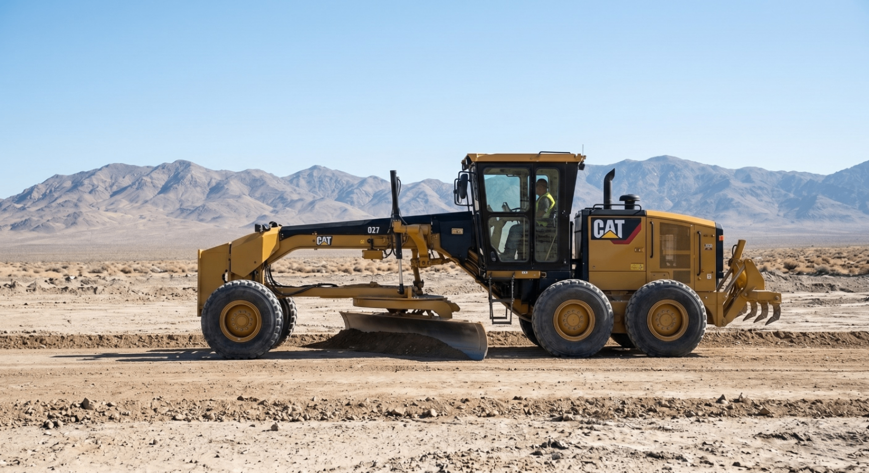 Motor grader shaping a Nevada construction pad